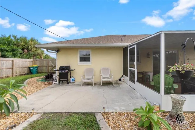a view of backyard with outdoor seating and plants