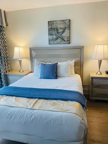 a bedroom with a bed and a night stand