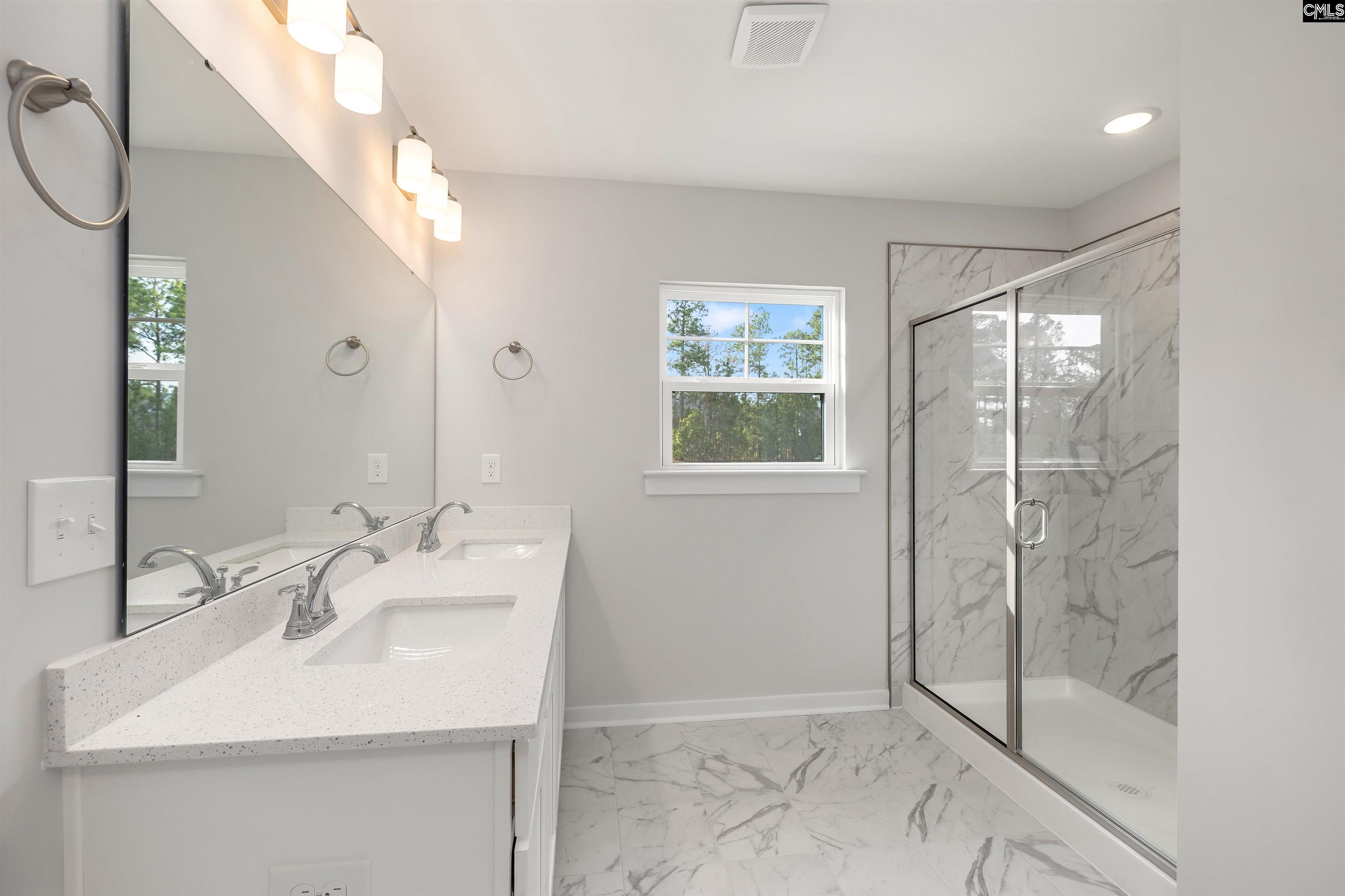 32 Fawn Spot Court Elgin, SC 29045 - Photo 18 of 28 a bathroom with a sink shower and a mirror