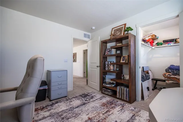 a view of a bedroom with workspace and bedroom