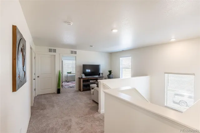 a view of living room kitchen with furniture and flat screen tv