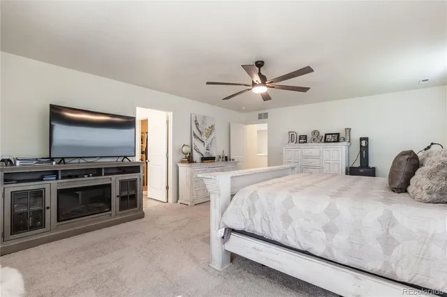 a bedroom with a large bed and a flat screen tv