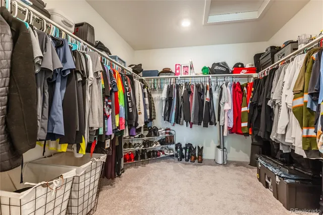 a view of walk in closet with clothes