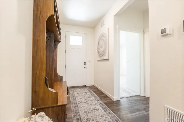 a view of hallway with wooden floor