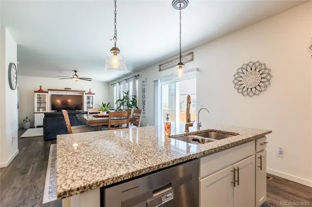 a kitchen with sink and refrigerator