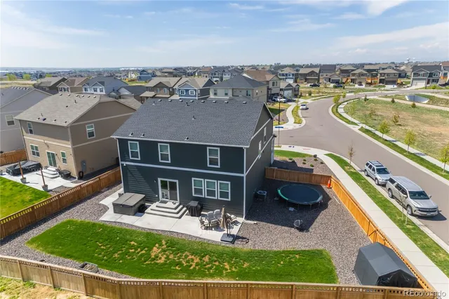 a view of a house with pool and chairs
