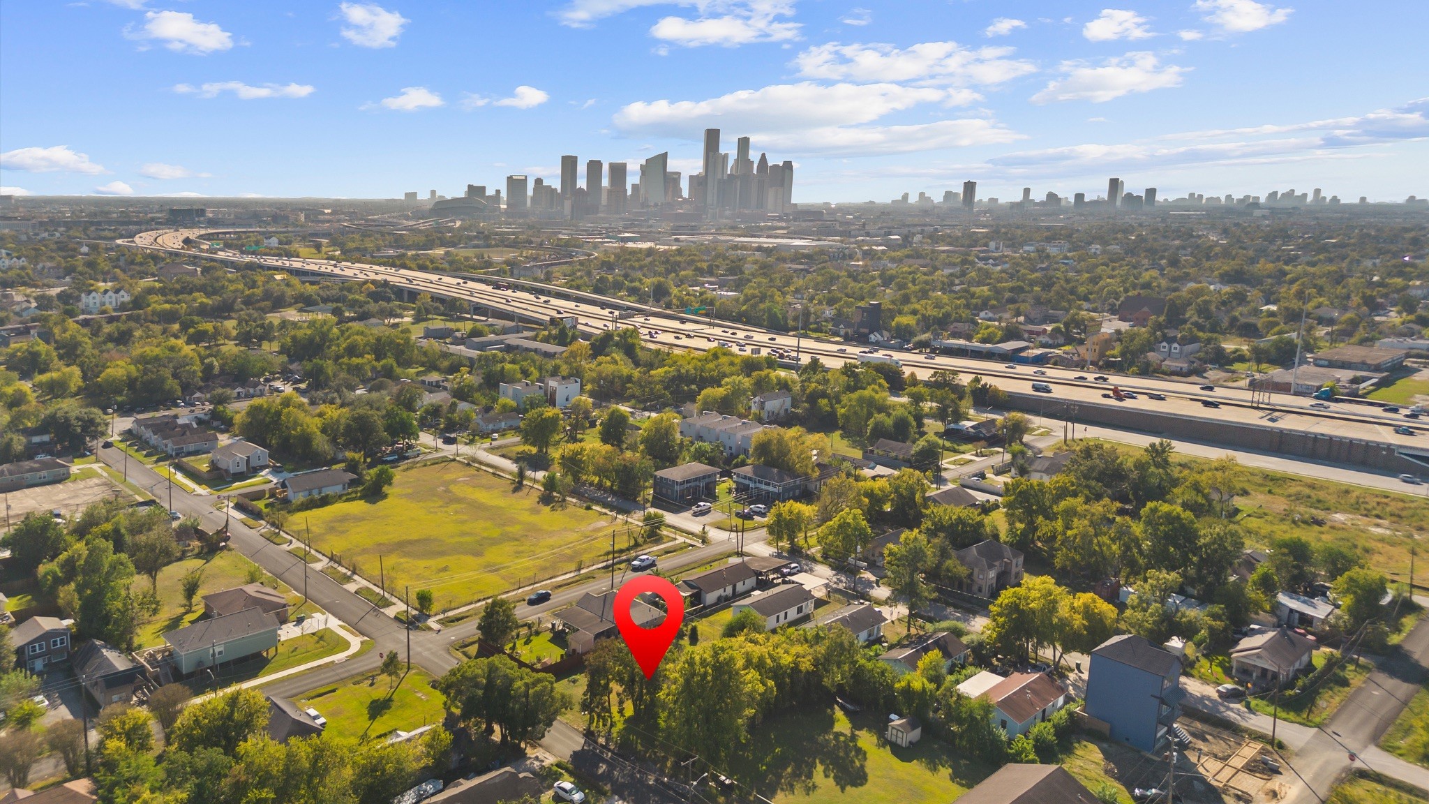 an aerial view of residential houses with city view