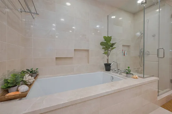 a bathroom with a bathtub and a shower