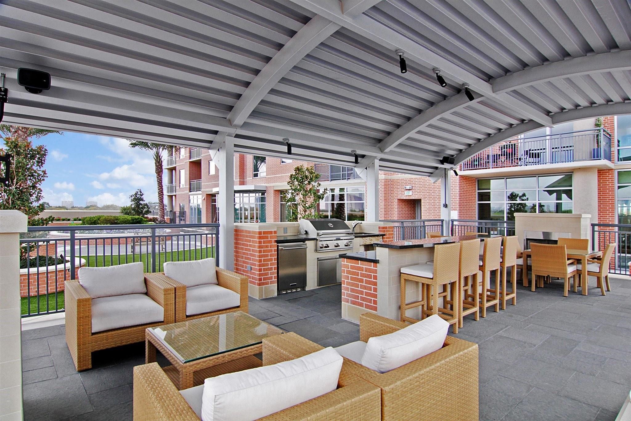 2207 Bancroft Lane, Unit 604 Houston, TX 77027 - Photo 24 of 35 a view of a chairs and tables in the back yard of a house