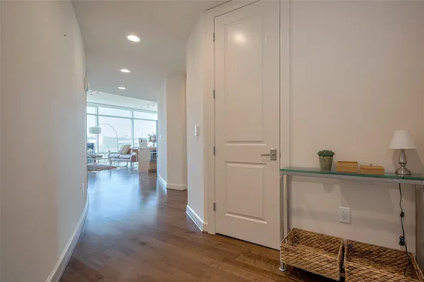 a view of a hallway and dining room with wooden floor