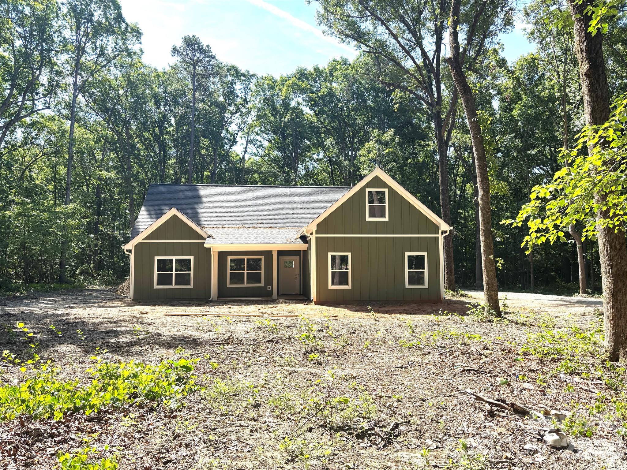 1818 New Salem Road Monroe, NC 28110 - Photo 2 of 8 a front view of a house with a yard and trees