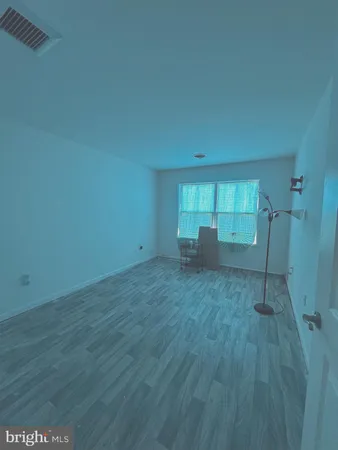 a view of an empty room and wooden floor
