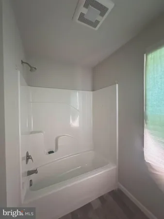a bath tub sitting next to a white sink