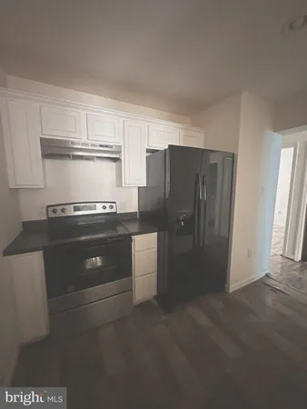 a kitchen with a refrigerator and a stove