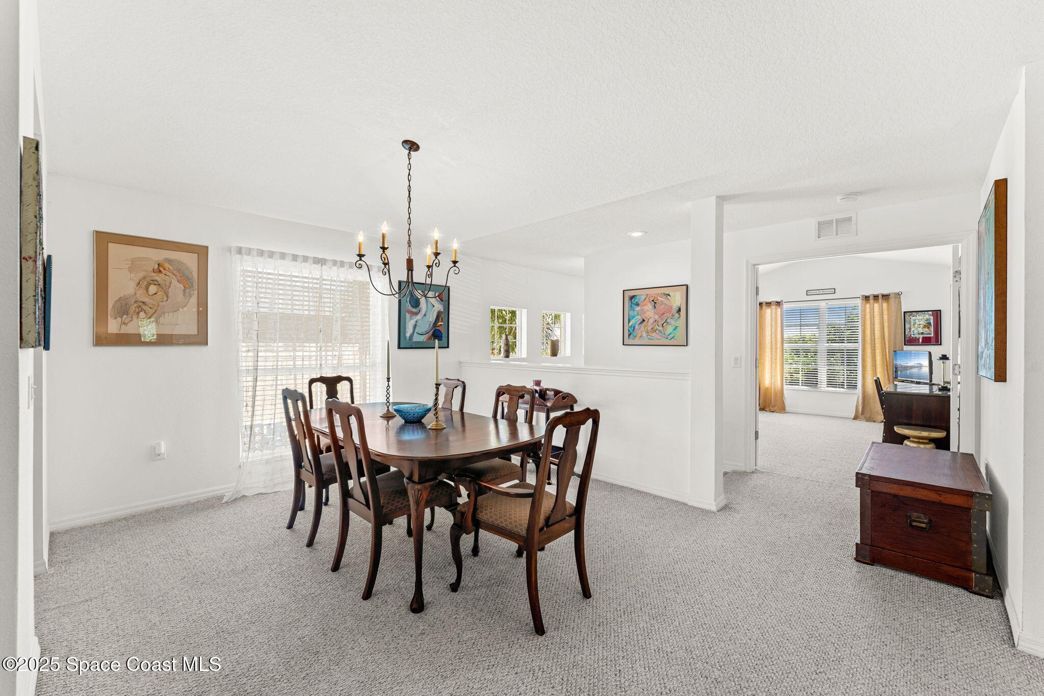 400 Trotter Lane, Unit 204 Melbourne, FL 32940 - Photo 13 of 38 a view of a dining room with furniture and chandelier