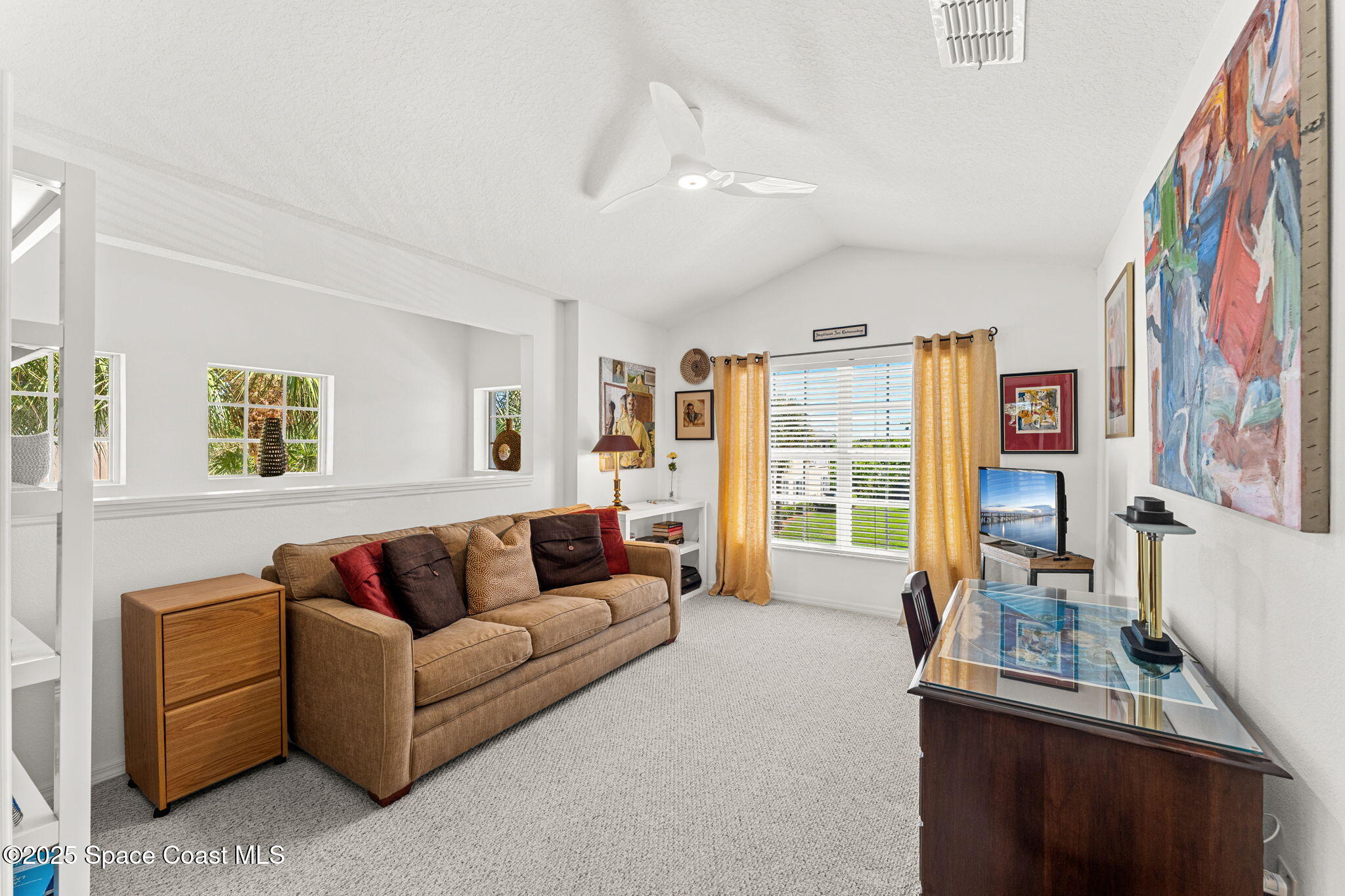400 Trotter Lane, Unit 204 Melbourne, FL 32940 - Photo 14 of 38 a living room with furniture and a window