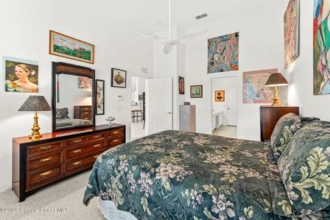 a bedroom with a bed and a dresser in it