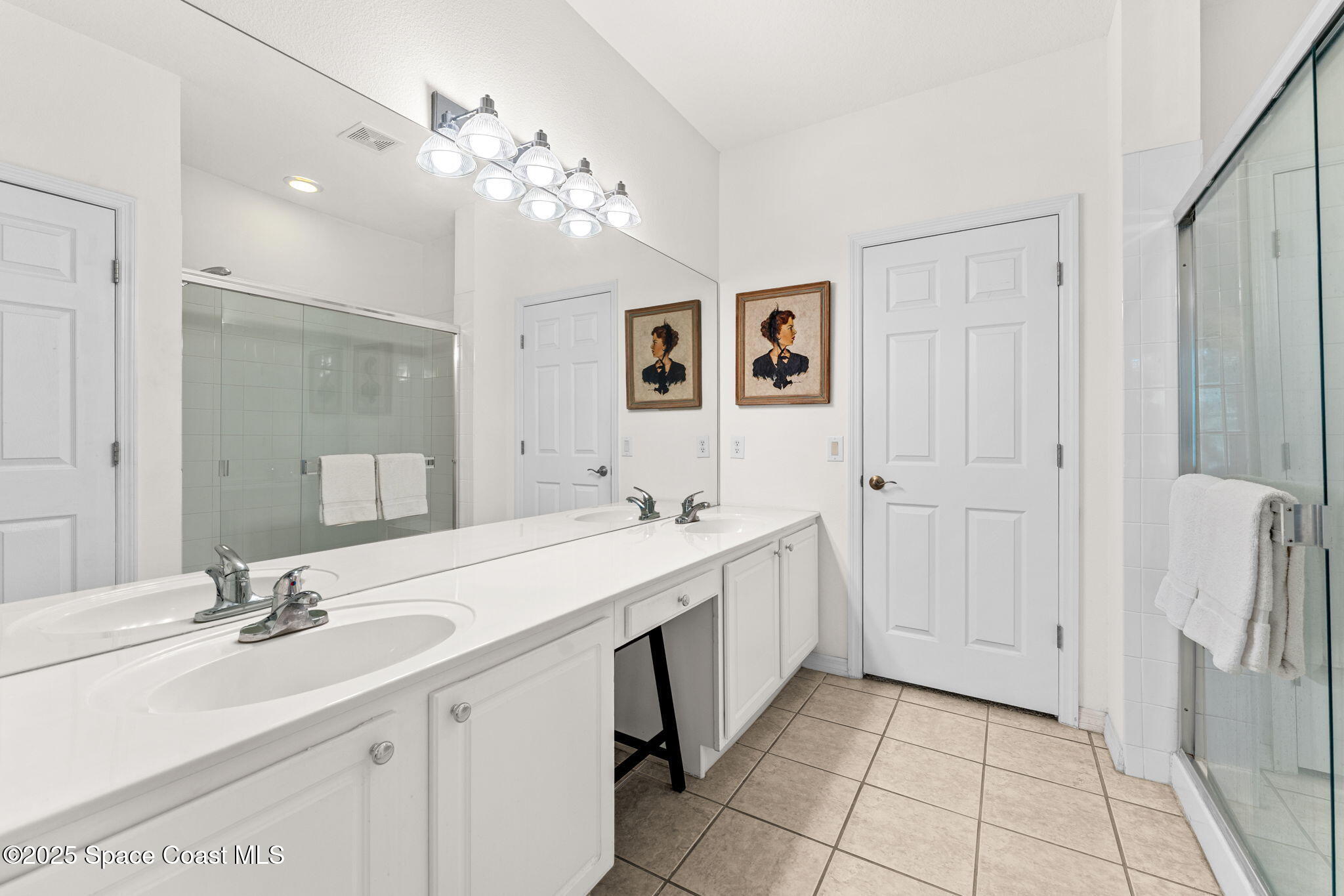 400 Trotter Lane, Unit 204 Melbourne, FL 32940 - Photo 18 of 38 a bathroom with a sink double vanity granite and a mirror
