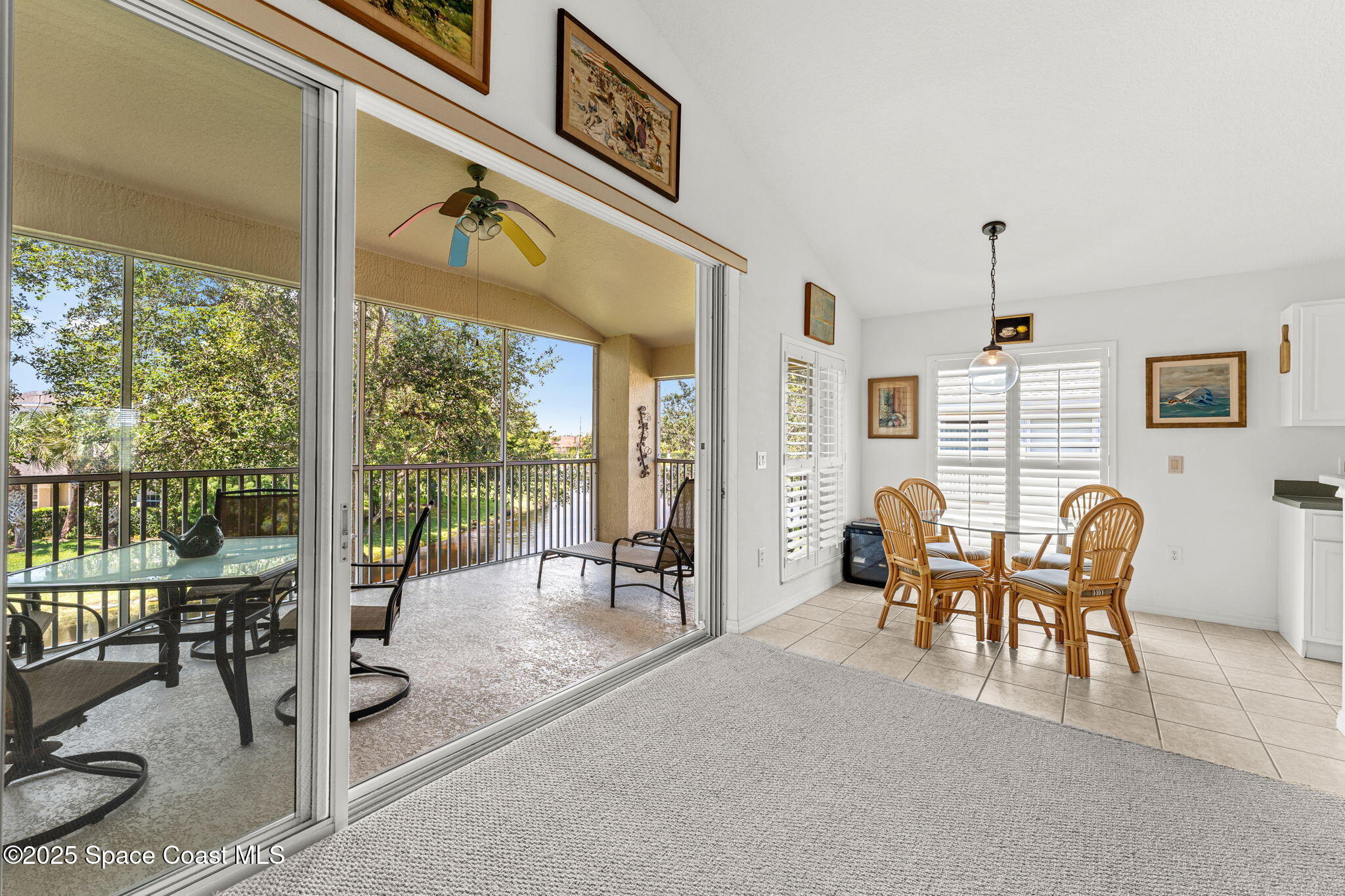 400 Trotter Lane, Unit 204 Melbourne, FL 32940 - Photo 21 of 38 a dining room with furniture water view and a floor to ceiling window