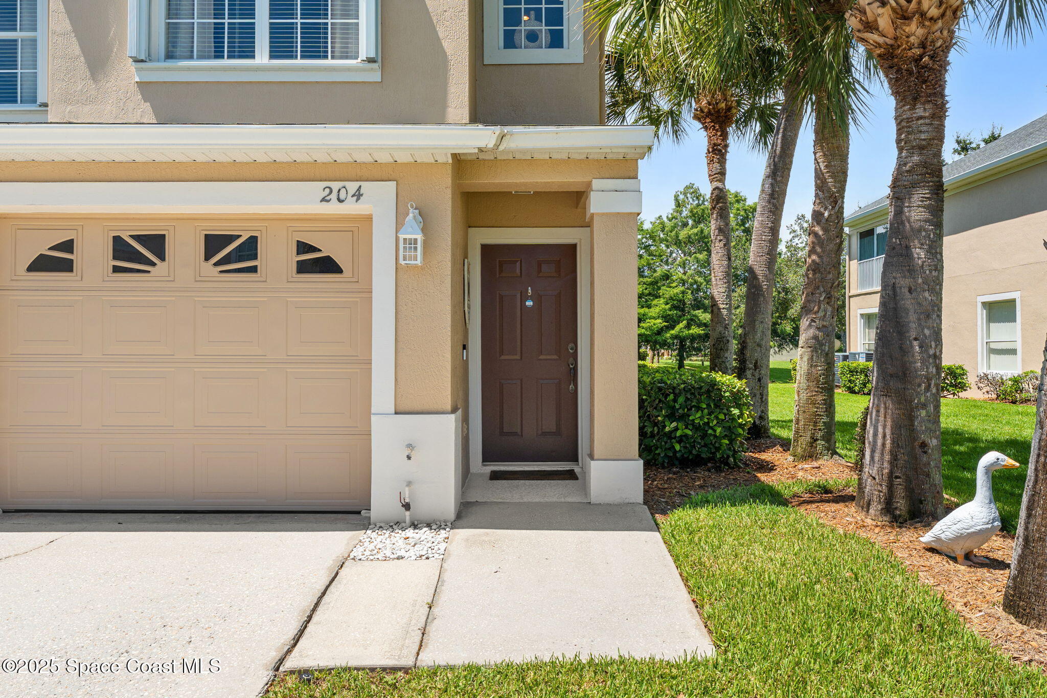 400 Trotter Lane, Unit 204 Melbourne, FL 32940 - Photo 30 of 38 a front view of a house with garden