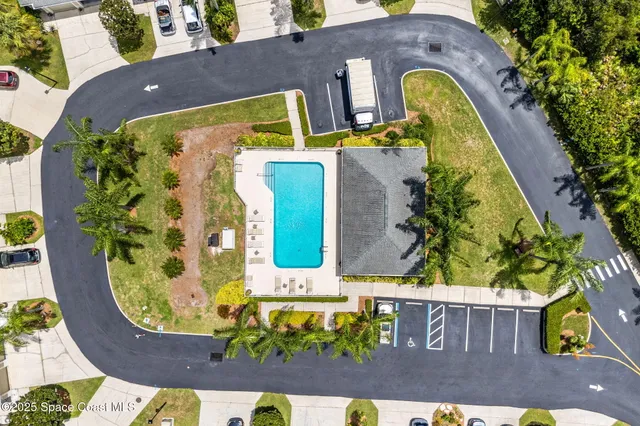 an aerial view of a house with a swimming pool
