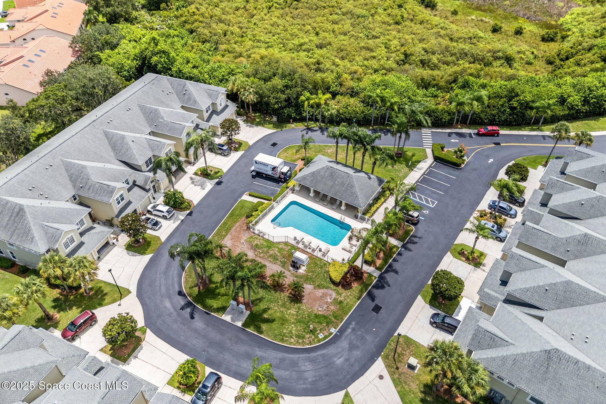 400 Trotter Lane, Unit 204 Melbourne, FL 32940 - Photo 32 of 38 an aerial view of a house with a garden and swimming pool
