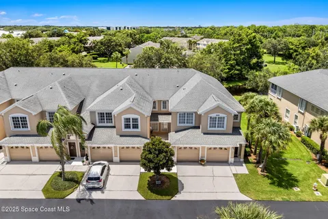 an aerial view of a house with a yard and potted plants
