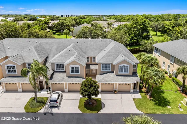 an aerial view of a house with a yard and potted plants