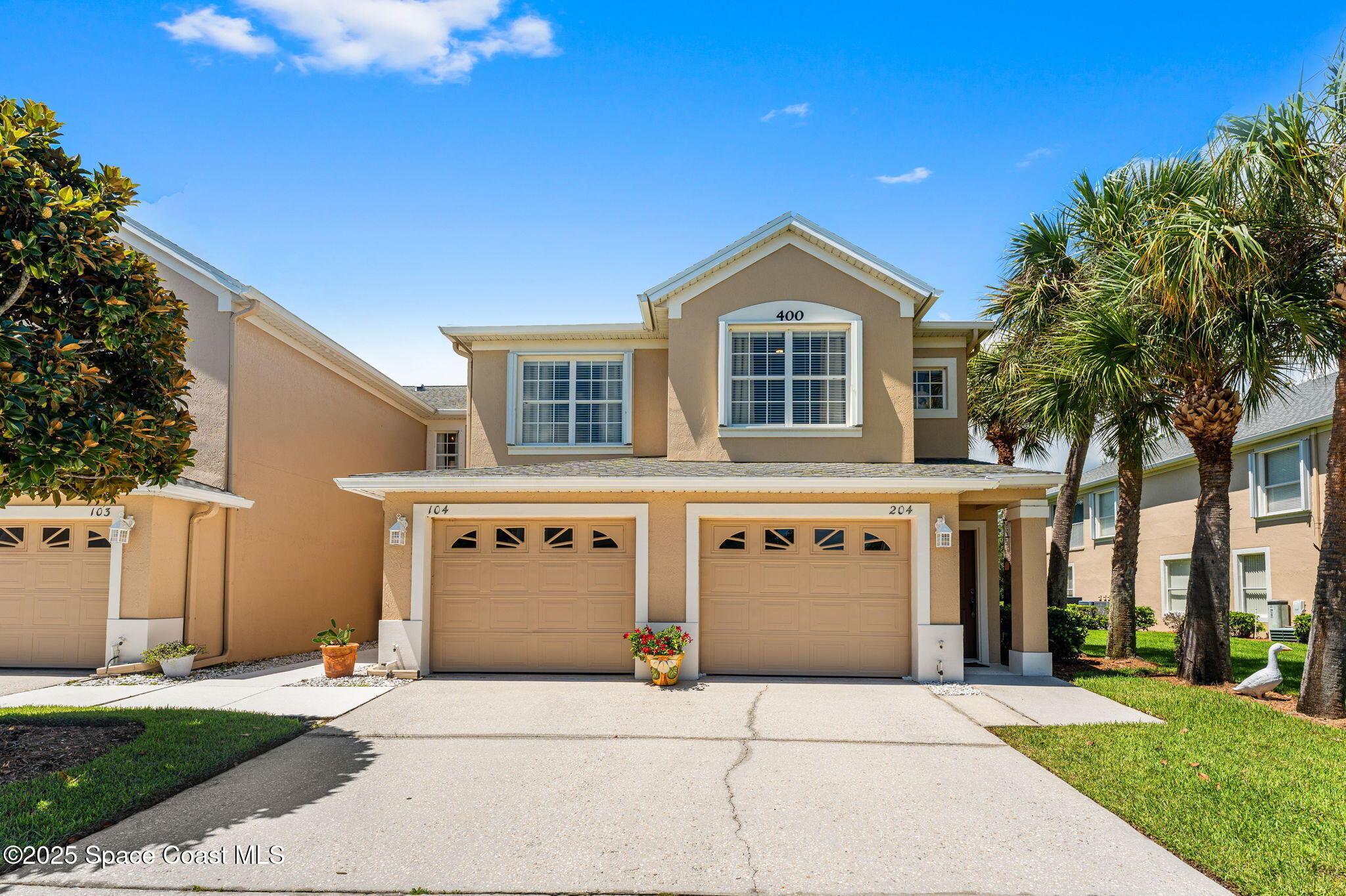 400 Trotter Lane, Unit 204 Melbourne, FL 32940 - Photo 37 of 38 a front view of a house with a yard