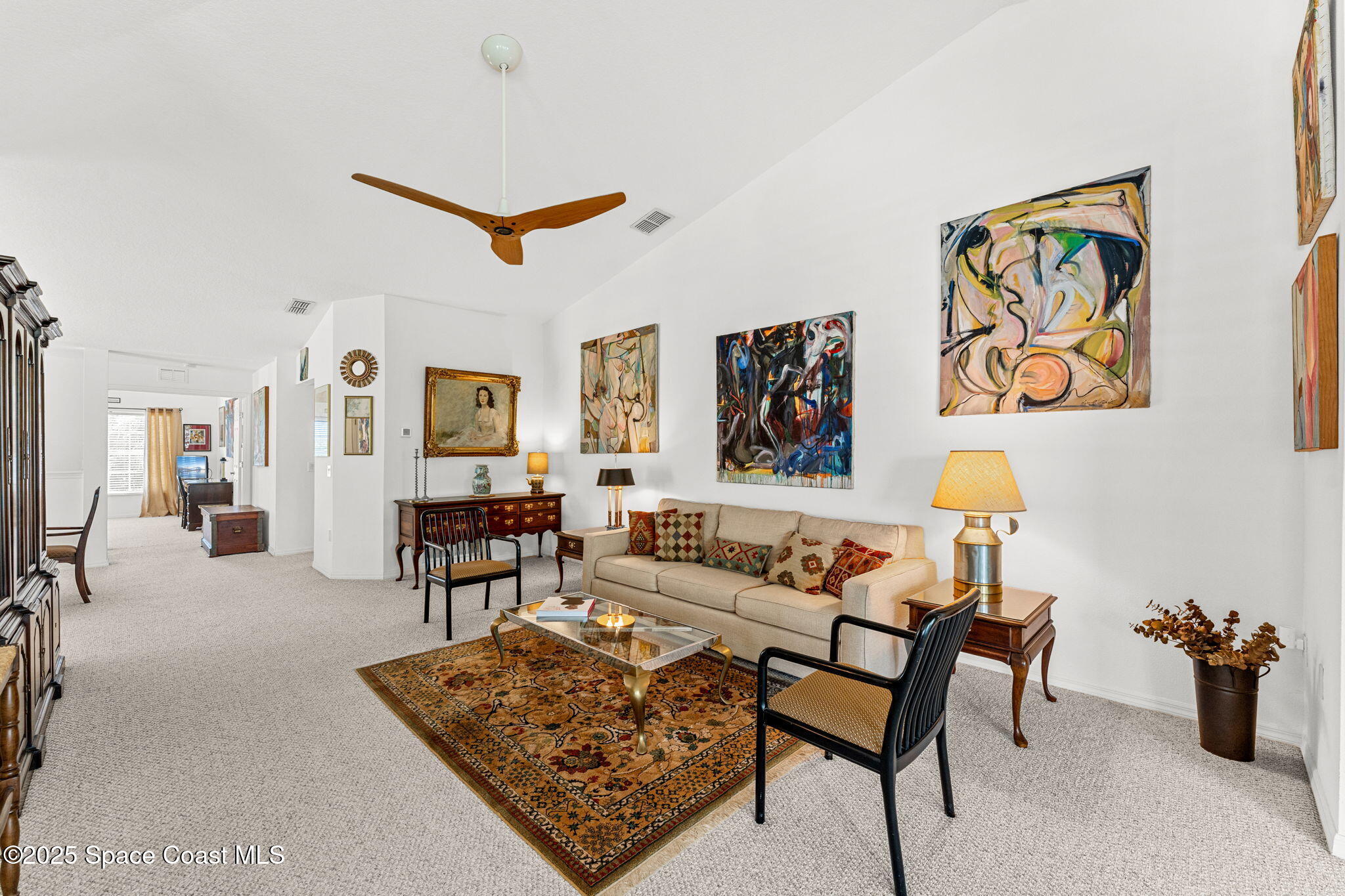 400 Trotter Lane, Unit 204 Melbourne, FL 32940 - Photo 7 of 38 a living room with furniture a rug and a table