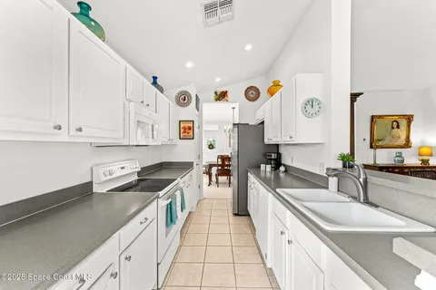 a kitchen with stainless steel appliances granite countertop a sink and cabinets