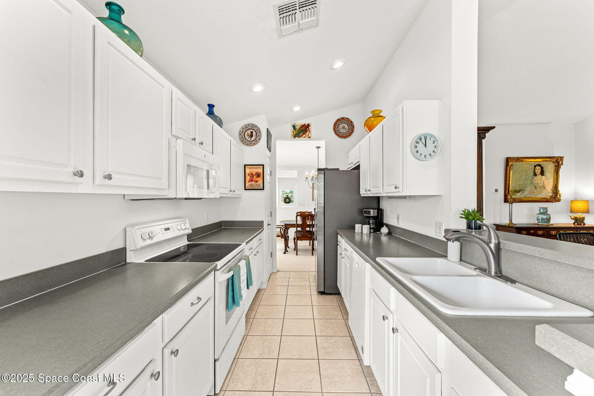 400 Trotter Lane, Unit 204 Melbourne, FL 32940 - Photo 10 of 38 a kitchen with stainless steel appliances granite countertop a sink and cabinets