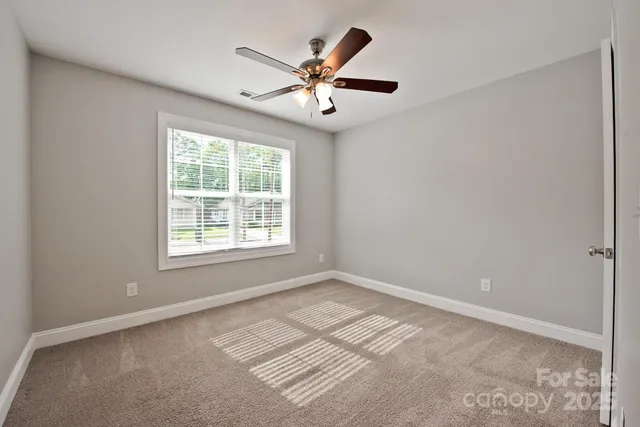 a view of room with window and ceiling fan