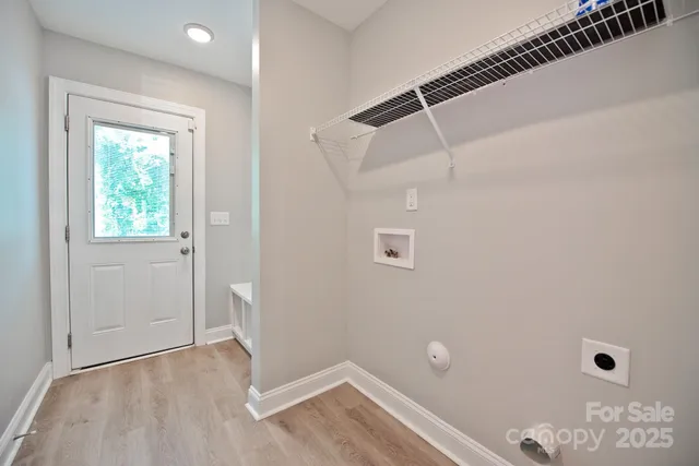 a view of a room with wooden floor and windows