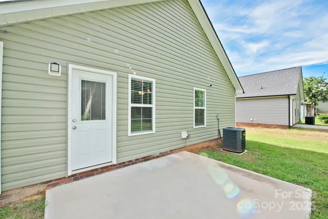 a house with a yard and potted plants
