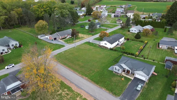 an aerial view of a residential houses with outdoor space and street view