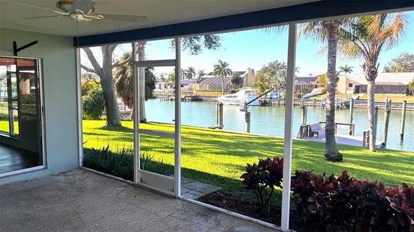 a view of a porch with chairs and a yard