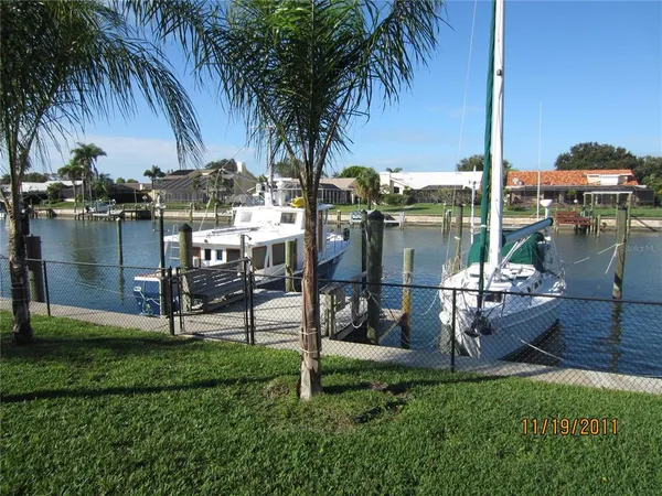 a view of swimming pool with garden and trees