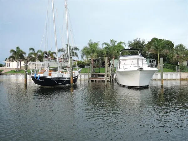 a view of a lake with boats next to a bridge