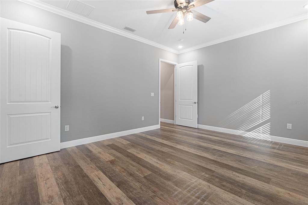 3183 East Fawn Court Inverness, FL 34452 - Photo 19 of 33 a view of an empty room with a chandelier fan