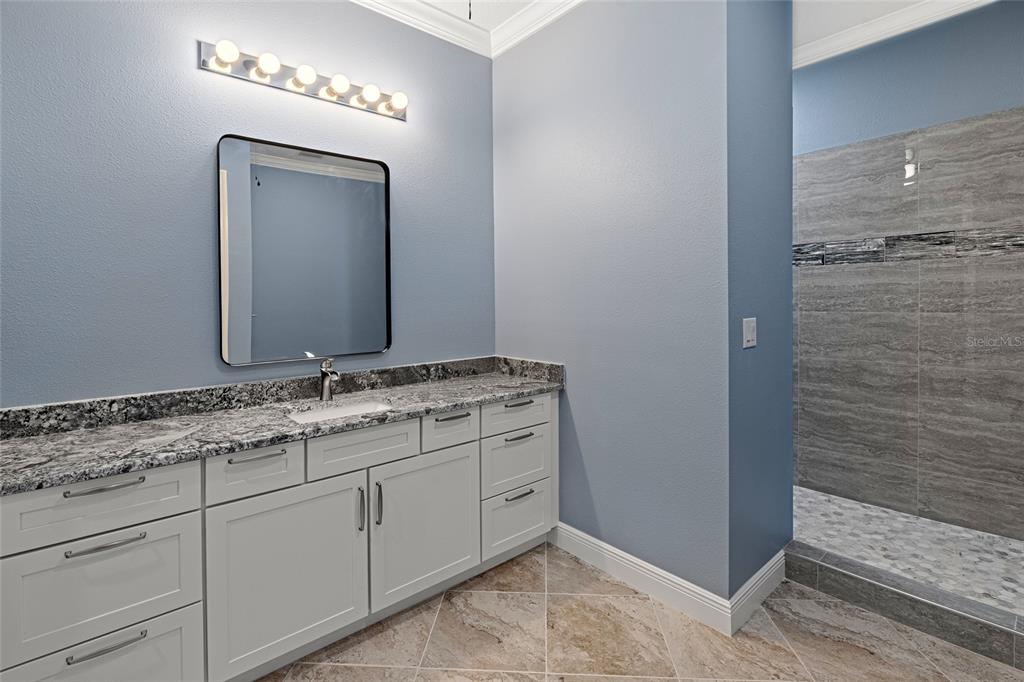 3183 East Fawn Court Inverness, FL 34452 - Photo 20 of 33 a bathroom with a double vanity sink and a mirror