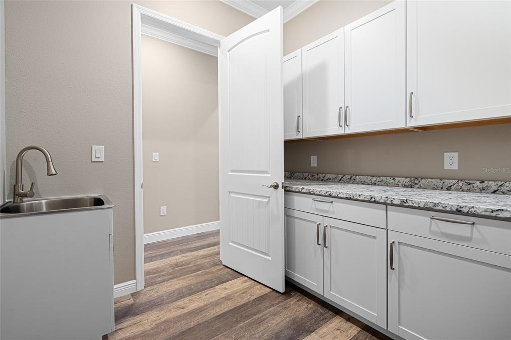 3183 East Fawn Court Inverness, FL 34452 - Photo 25 of 33 a kitchen with granite countertop white cabinets and white appliances