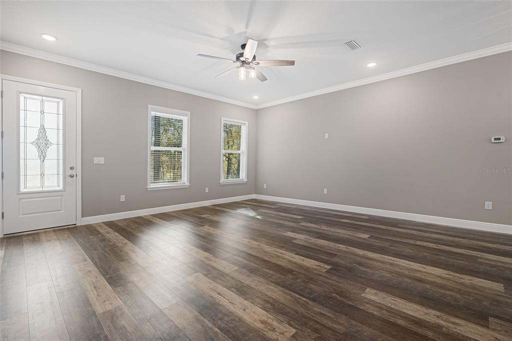 3183 East Fawn Court Inverness, FL 34452 - Photo 4 of 33 wooden floor in an empty room with a window