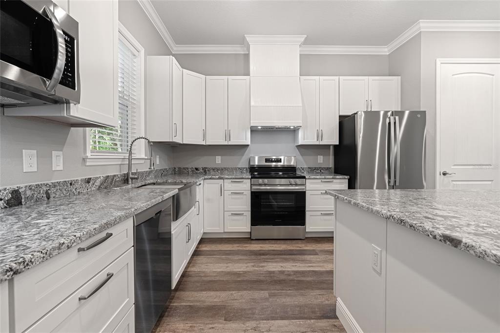 3183 East Fawn Court Inverness, FL 34452 - Photo 7 of 33 a kitchen with granite countertop a sink stove and refrigerator