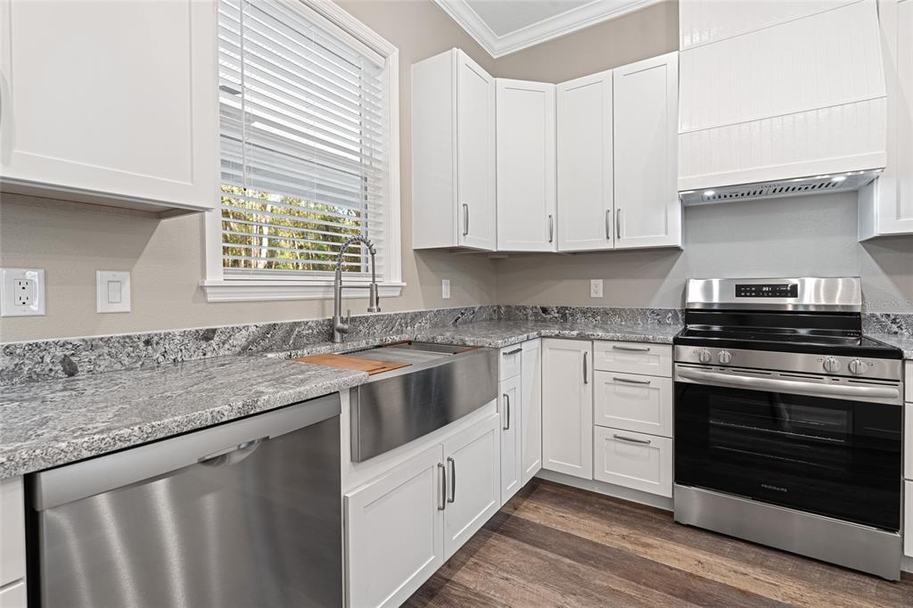 3183 East Fawn Court Inverness, FL 34452 - Photo 8 of 33 a kitchen with stainless steel appliances granite countertop a sink stove and cabinets