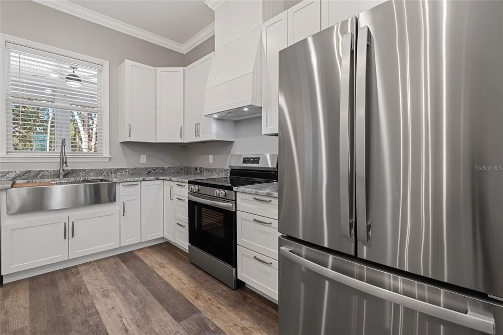 3183 East Fawn Court Inverness, FL 34452 - Photo 9 of 33 a kitchen with stainless steel appliances a refrigerator sink and cabinets