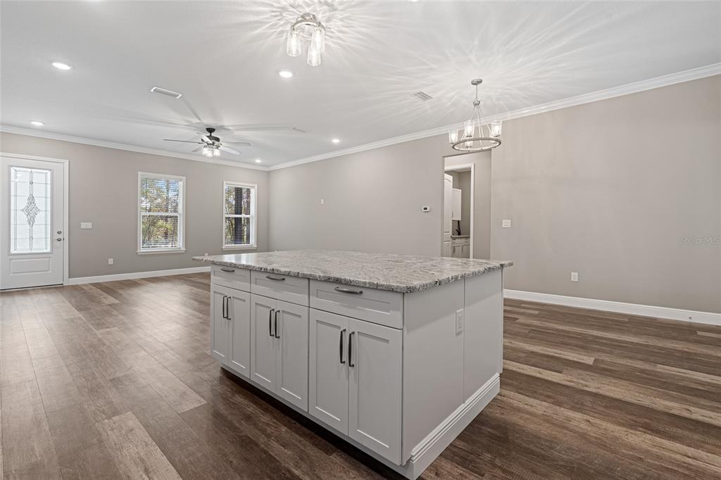 3183 East Fawn Court Inverness, FL 34452 - Photo 10 of 33 an empty room with wooden floor and window