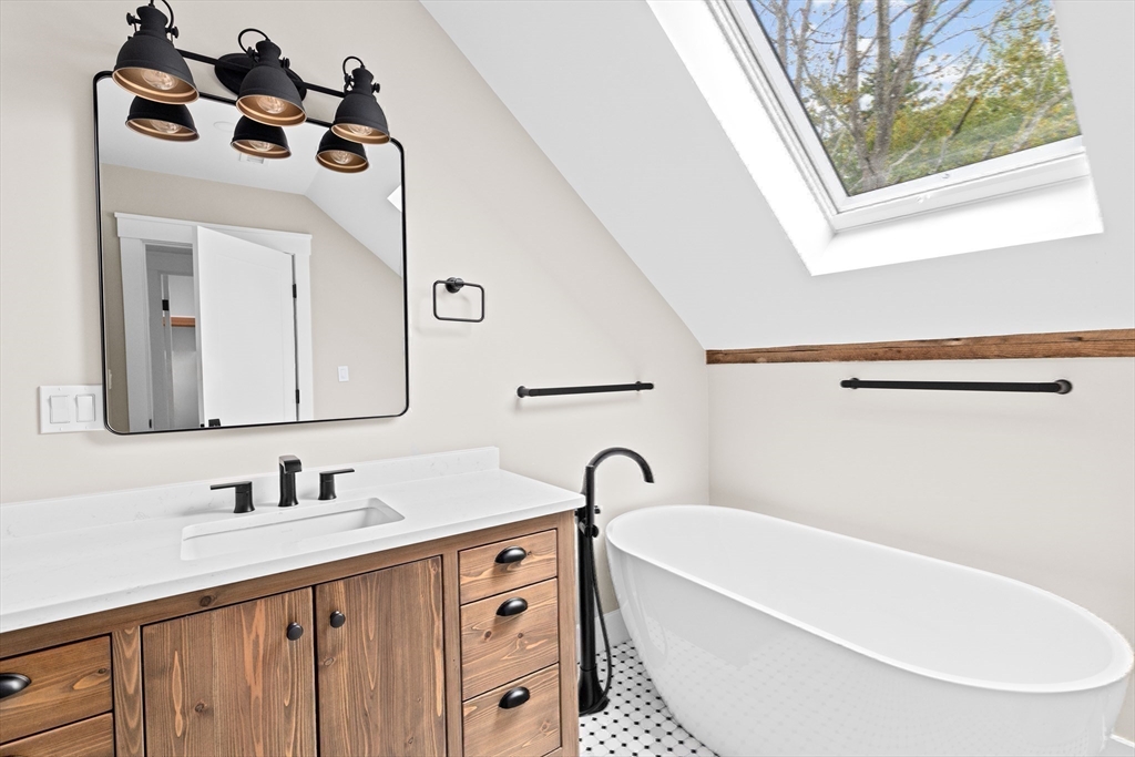 42 Captain Peirce Road Scituate, MA 02066 - Photo 24 of 40 a bathroom with a double vanity sink mirror and bathtub