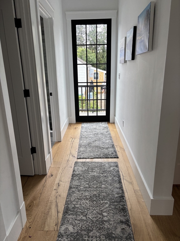 42 Captain Peirce Road Scituate, MA 02066 - Photo 38 of 40 a view of a hallway with wooden floor and a corridor