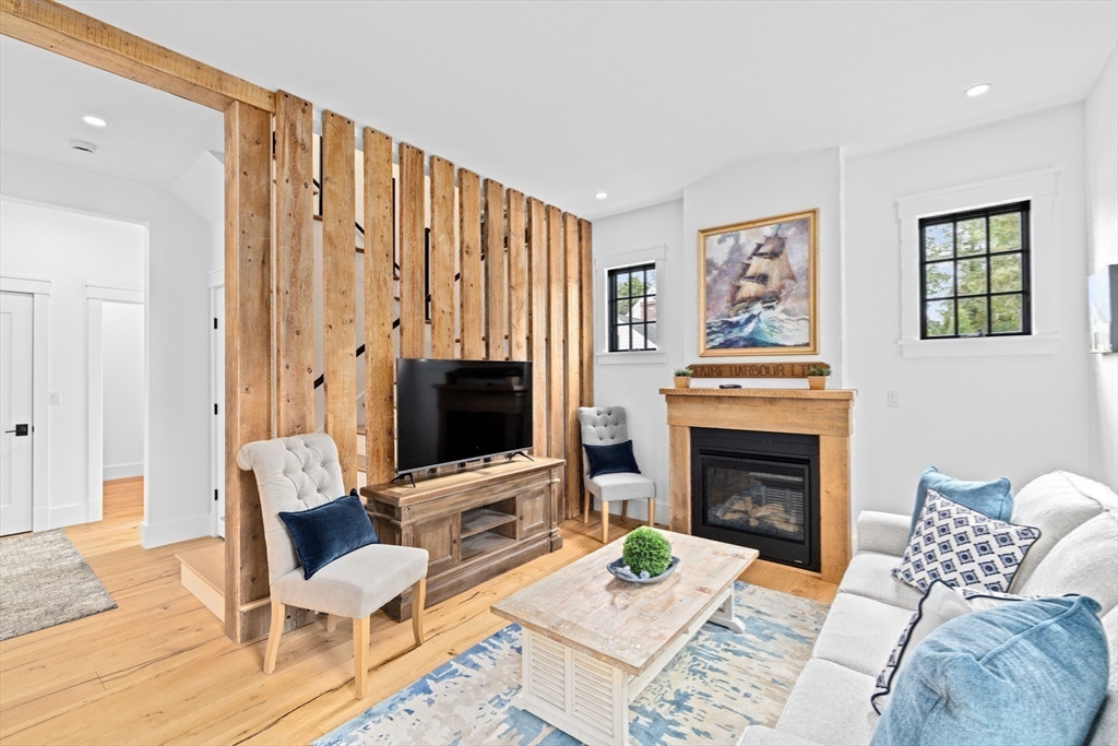42 Captain Peirce Road Scituate, MA 02066 - Photo 6 of 40 a living room with furniture a fireplace and a flat screen tv